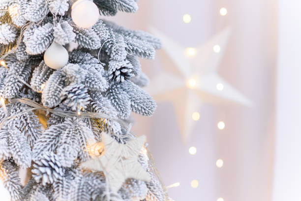 istock Close up of white decorations on artificial white Christmas tree with with snow. 2185293351