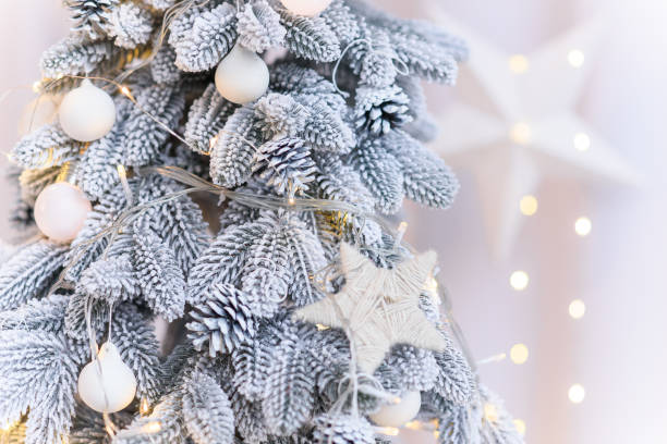 istock Close up of white decorations on artificial white Christmas tree with with snow. 2185293352