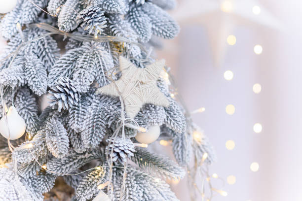 istock Close up of white decorations on artificial white Christmas tree with with snow. 2185293400