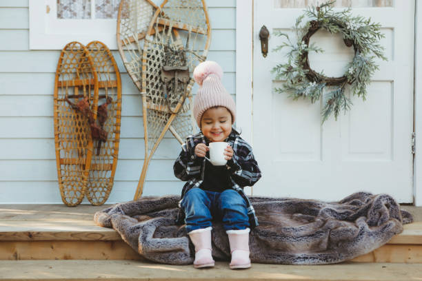 istock Little Girl on a Charming Rustic Porch with Hot Chocolate 2185293819