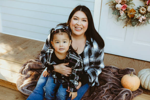 istock Little Girl and Mom on a Charming Rustic Porch 2185293929