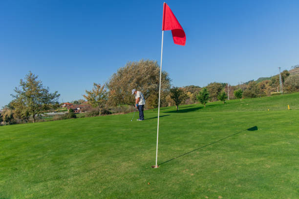 istock copyspace senior golfer putting ball toward flag on the green 2185295261