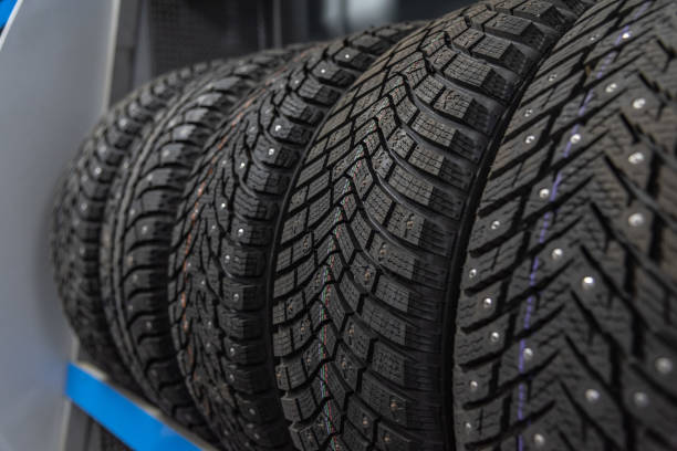 istock row of studded tyres in shop 2185295334