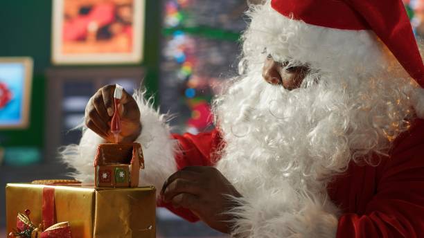 istock Saint Nicholas surrounded by Christmas decorations glazing gingerbread cookies 2185298190