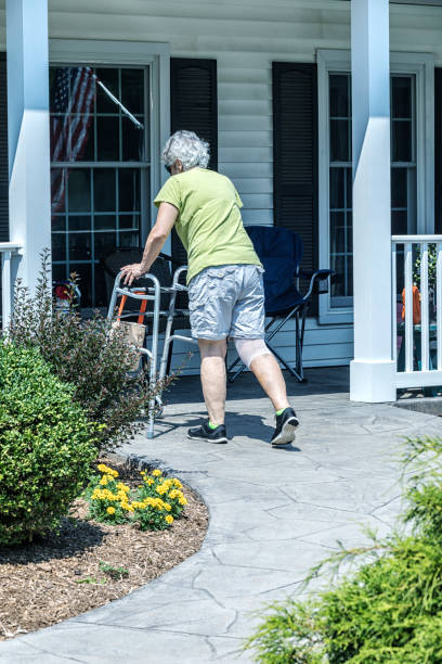 istock Recovering Knee Replacement Patient Finishing Her Daily Physical Therapy Walk 2185298868