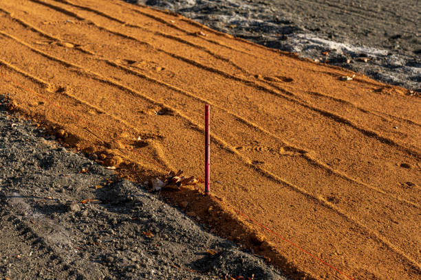 istock Edge of the base path with infield surface clay for a newly constructed baseball field. 2185299156