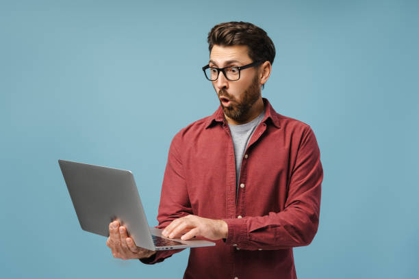 istock Excited, shocked Latin man, professional programmer using laptop, copywriter typing on keyboard 2185299713