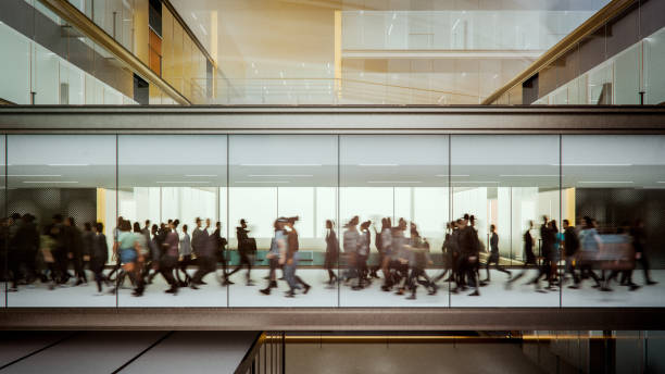 istock Motion blur of people walking in modern walkway 2185299879