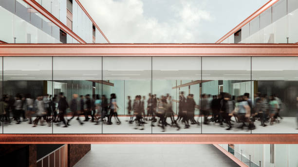 istock Motion blur of people walking in modern walkway 2185299893