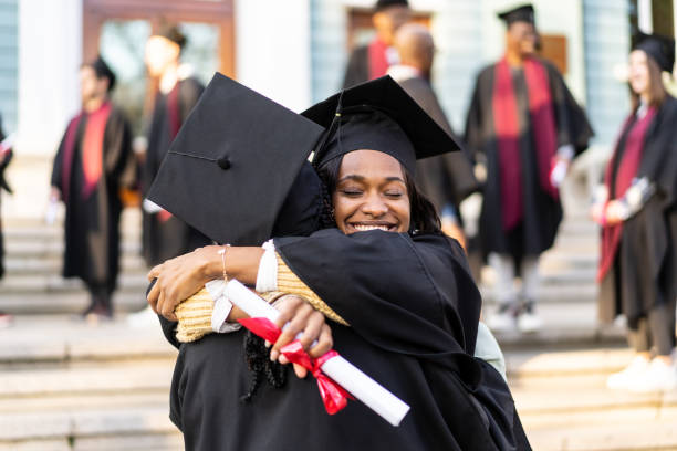istock Two females graduates embacing 2185299921