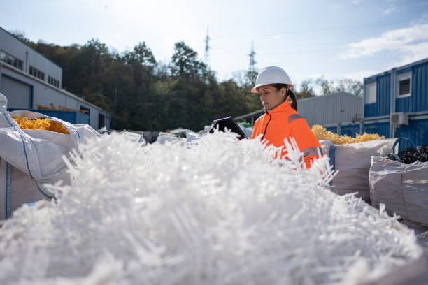 istock Worker Checks Plastic Resins Ready for Reuse in Manufacturing 2185301428