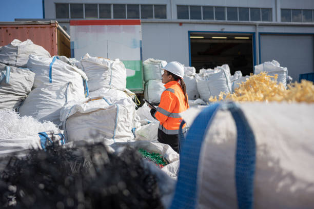 istock Worker Inspecting Plastic Resin Pellets in Recycling Factory 2185301438