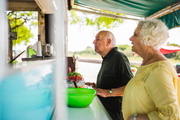 istock Senior Couple Ordering from Food Truck 2185302784