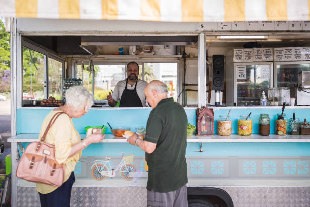 istock Food Truck Serving Customers on Sunny Day 2185302800