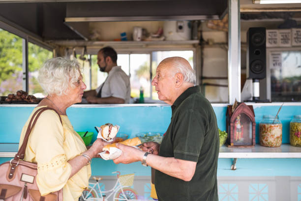 istock Friendly Conversation at Food Stand in Daytime 2185302804