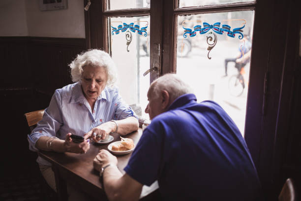 istock Senior Couple Enjoying Morning Coffee in Cafe 2185302923