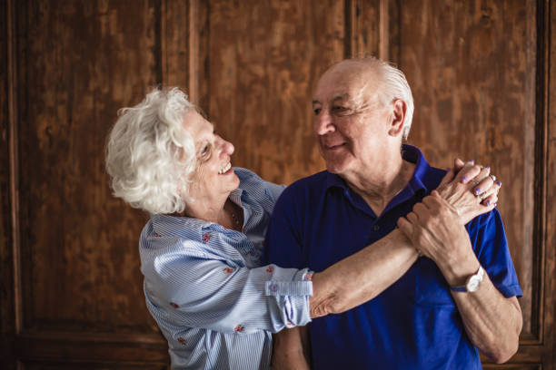 istock Happy Elderly Couple Embracing in Afternoon Light 2185302989