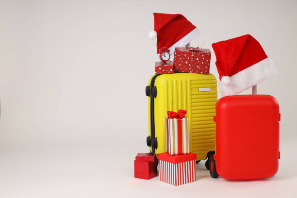 istock Suitcases with a New Year's hat and gifts 2185303151