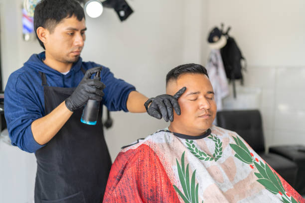 istock Barber applying hairspray to a client's hair 2185305870