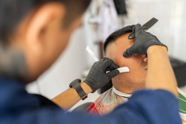 istock Latin traditional barber hand-shaving a client's beard 2185306633