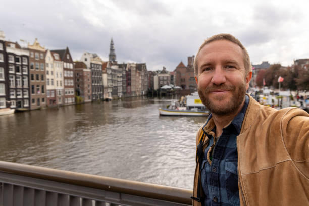 istock Man Taking a Selfie at a Scenic European Canal 2185313820