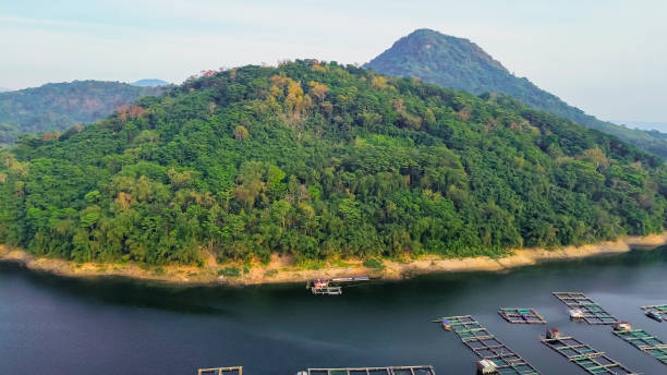 istock Fish farming in floating cages on tranquil waters surrounded by lush hills in a serene location. Jatiluhur reservoir 2185314334