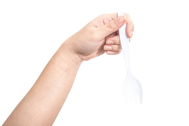 istock Female hand holding a white plastic fork isolated on white background 2185315334