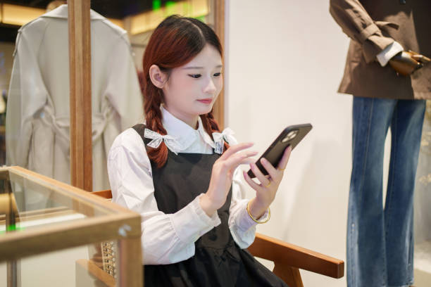 istock Young Asian man looking at smartphone 2185316756