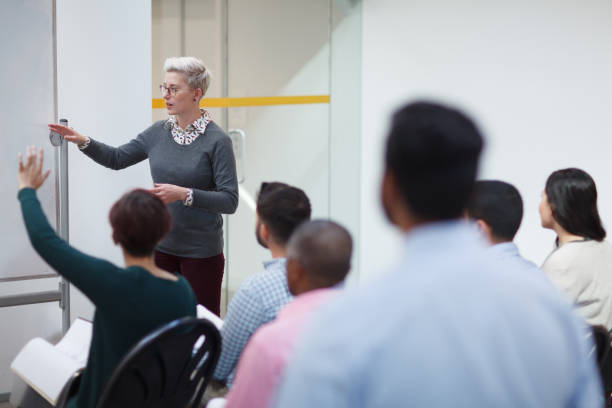 istock Young woman teacher teaching talking discussion in seminar class with group of students for education training 2185316920