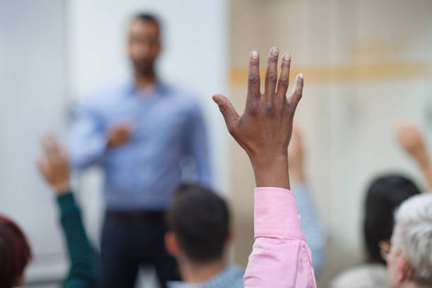 istock Black ethnicity man hand raised in class lecture training seminar in education school classroom asking question to teacher 2185316992