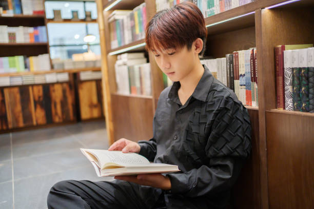 istock Asian college students reading in the library 2185317069