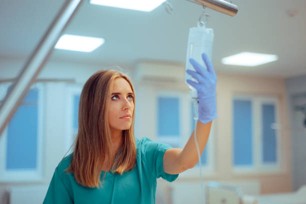 istock Professional Nurse Checking Iv Bag Medication in a Hospital 2185318562