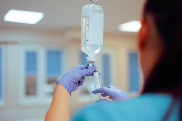 istock Nurse Preparing Iv Bag Injecting Medication in a Hospital 2185318563