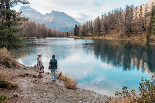 istock Couple Strolling by Scenic Mountain Lake 2185323499