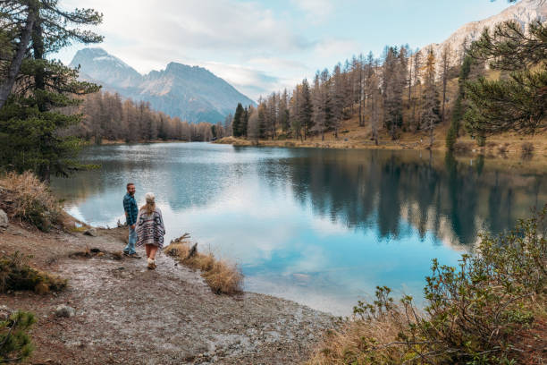 istock Couple Strolling by Scenic Mountain Lake 2185323525