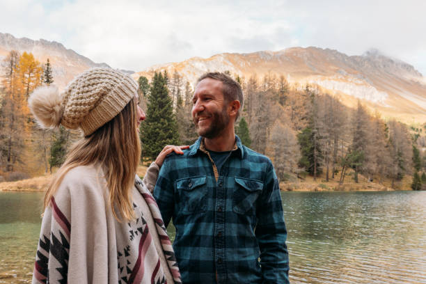 istock Couple Admiring Mountain Lake Scenery 2185324256
