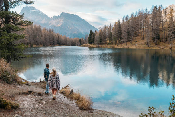 istock Couple Strolling by Scenic Mountain Lake 2185324267
