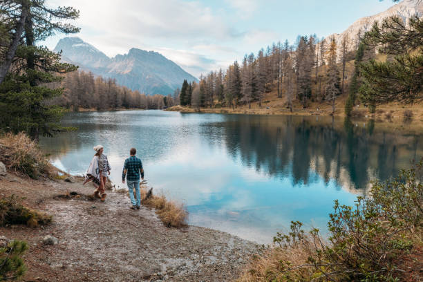istock Couple Strolling by Scenic Mountain Lake 2185324268