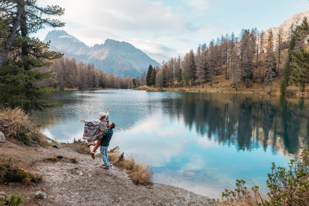 istock Couple Embracing by a Scenic Mountain Lake 2185324275