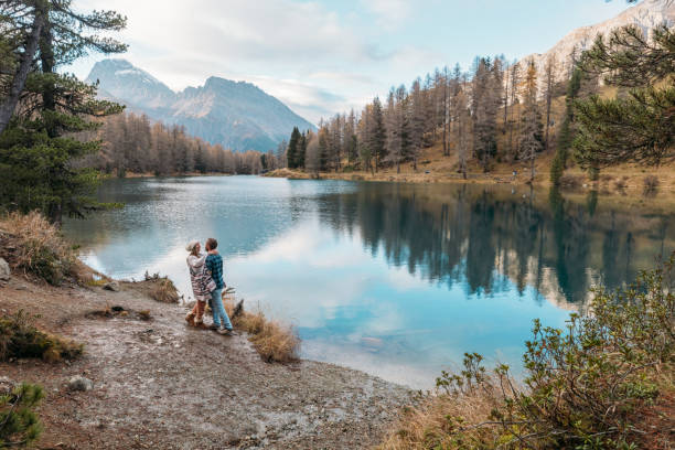 istock Couple Admiring Mountain Lake Scenery 2185324281