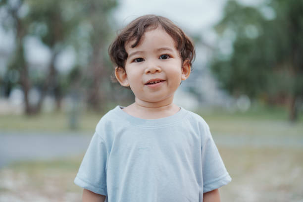istock Cute Asian boy having fun while playing on the playground on sunny day. Outdoor activity. 2185325580