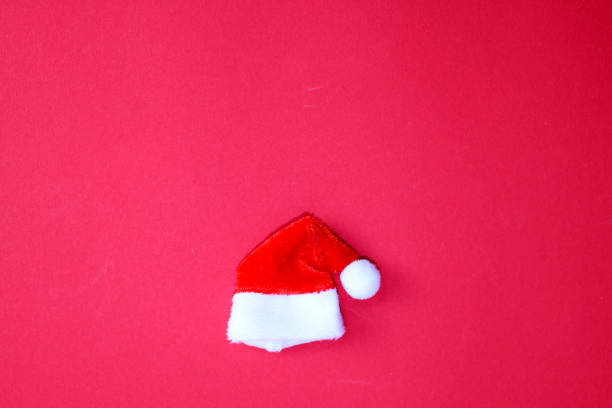 istock Santa Claus hat on red background. 2185327461