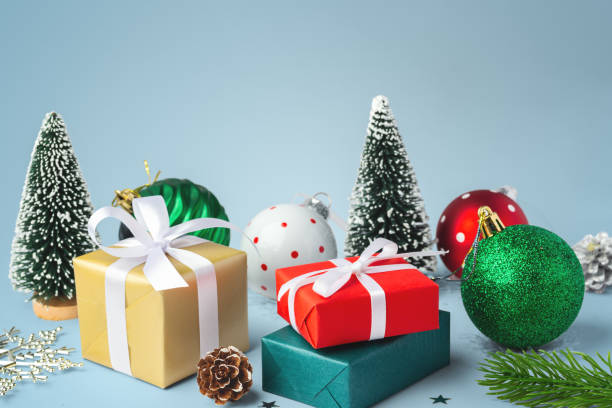 istock Gift box present with christmas balls and decoration on blue background 2185329955