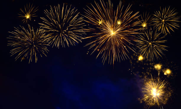 istock Golden fireworks burst in night sky 2185330628