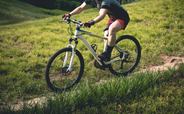 istock Woman mountain biking on mountain trail 2185330657