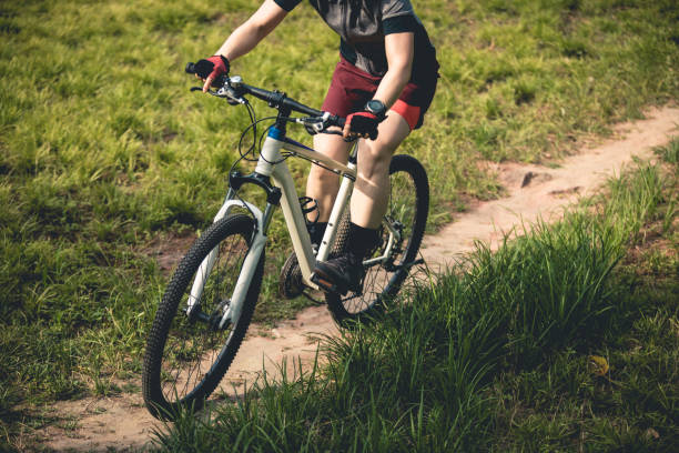 istock Woman mountain biking on mountain trail 2185331311