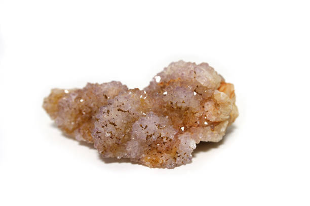 Purple fluorite crystal with white and green minerals on a white background, creating a beautiful display of colors and textures