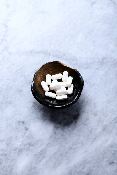 istock Korean Ginseng tablets. Concept for a healthy dietary supplementation. Bright stone background. Soft focus. Copy space. 2185336039