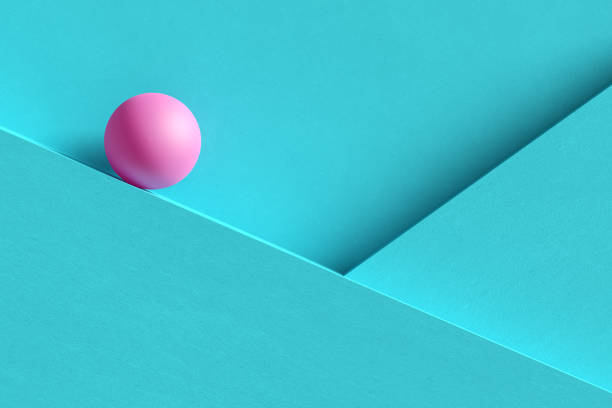 Pink sphere rolling over blue wall background. Abstract geometric background, creating uncertainty. Vibrant colors and clean lines evoke balance in this modern graphic backdrop. 3d render.