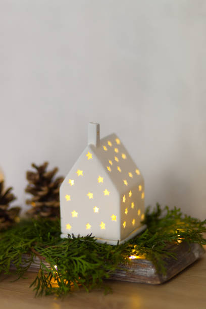 istock Winter and christmas decoration with small illuminated house 2185338858